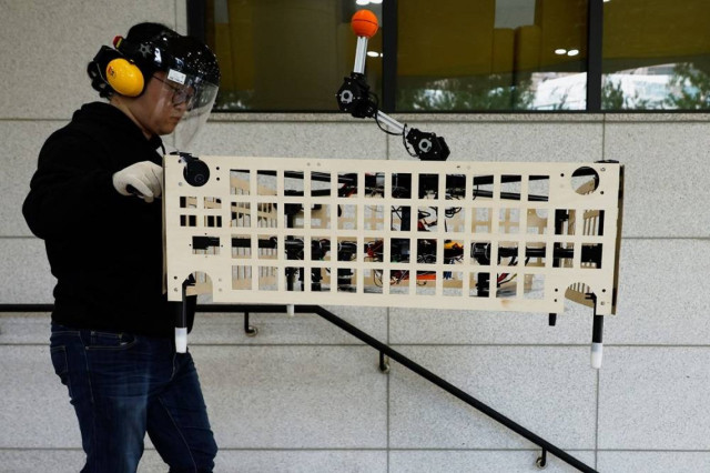 Park Hyun-geun, a graduate student of Mechanical Design and Robot Engineering at Seoul National University of Science and Technology (Seoul Tech), demonstrates the aerial transportation platform "Palletrone" on stairs at the Seoul Tech in Seoul, South Kor